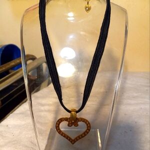 Not new,never worn black cording chocker 12in long &3in gold chain& gold heart.